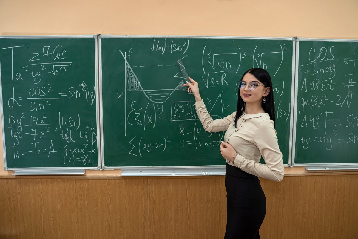 1600young teacher student standing near blackboard learn math lesson education concept